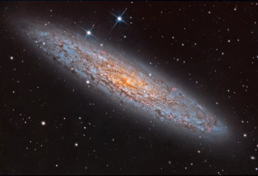 عکس روز ناسا NGC 253 کهکشان غبارآلود.webp